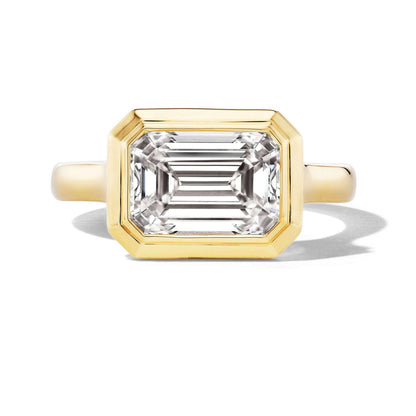 Bezel set east west emerald cut diamond ring