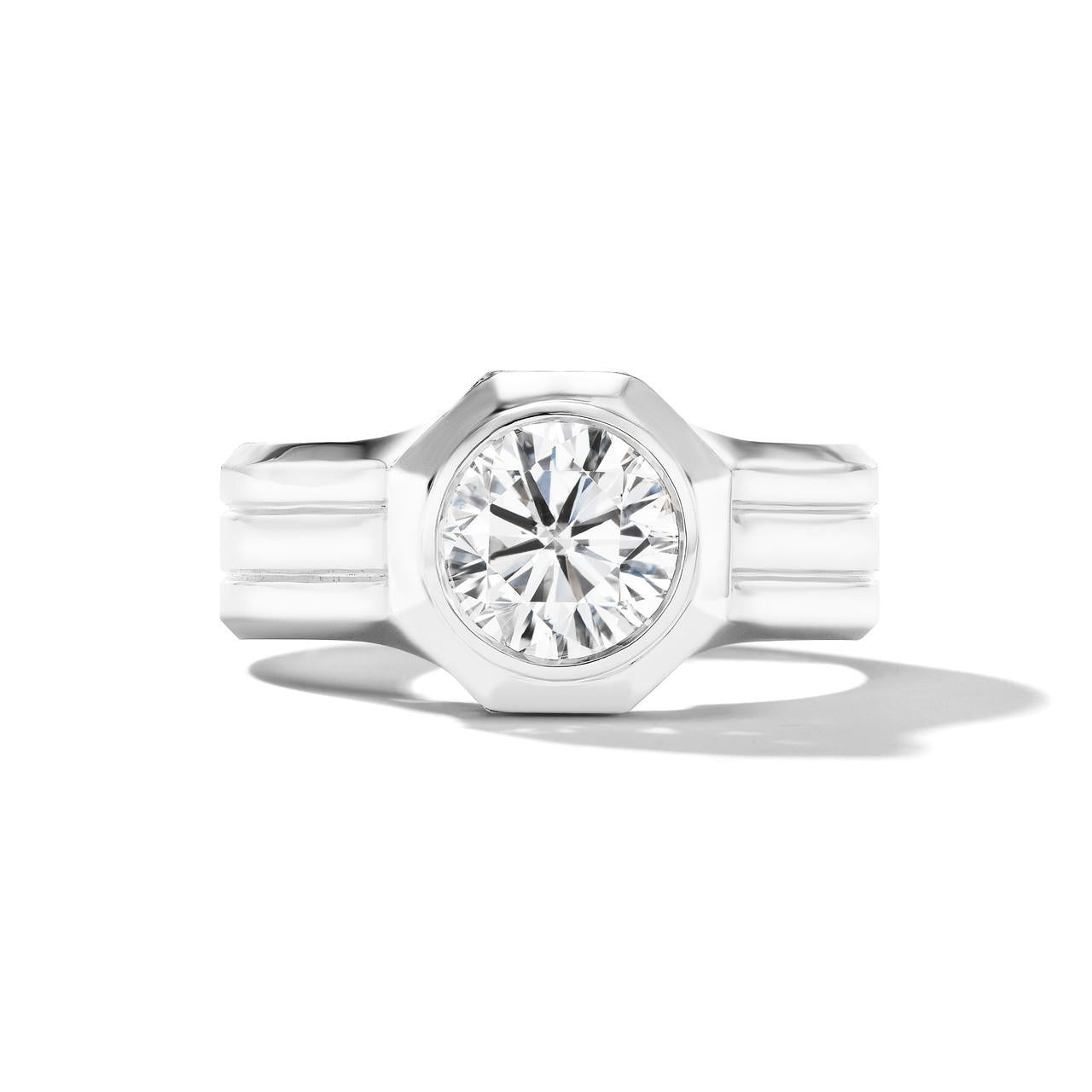 Shield octagon round diamond engagement ring with a triple band in platinum