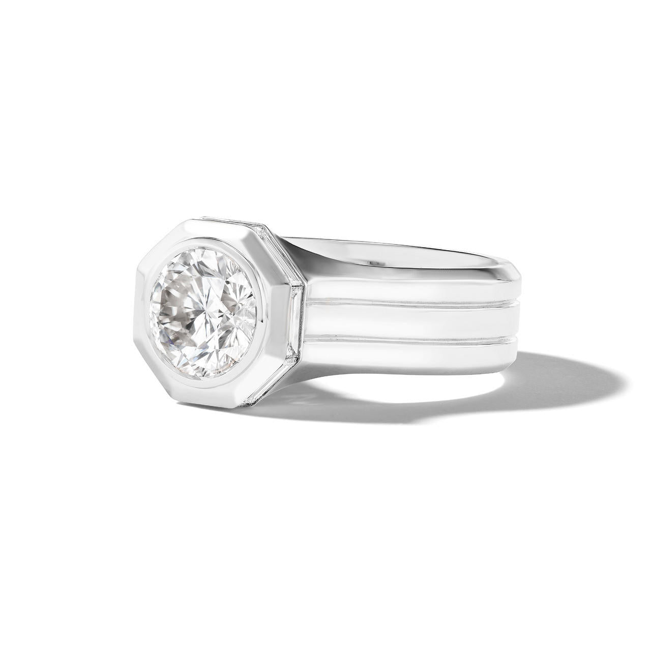 Shield octagon round diamond engagement ring with a triple band in platinum