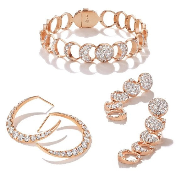 Pair of gold and diamond hoop earrings with round brilliant diamonds on a white background.