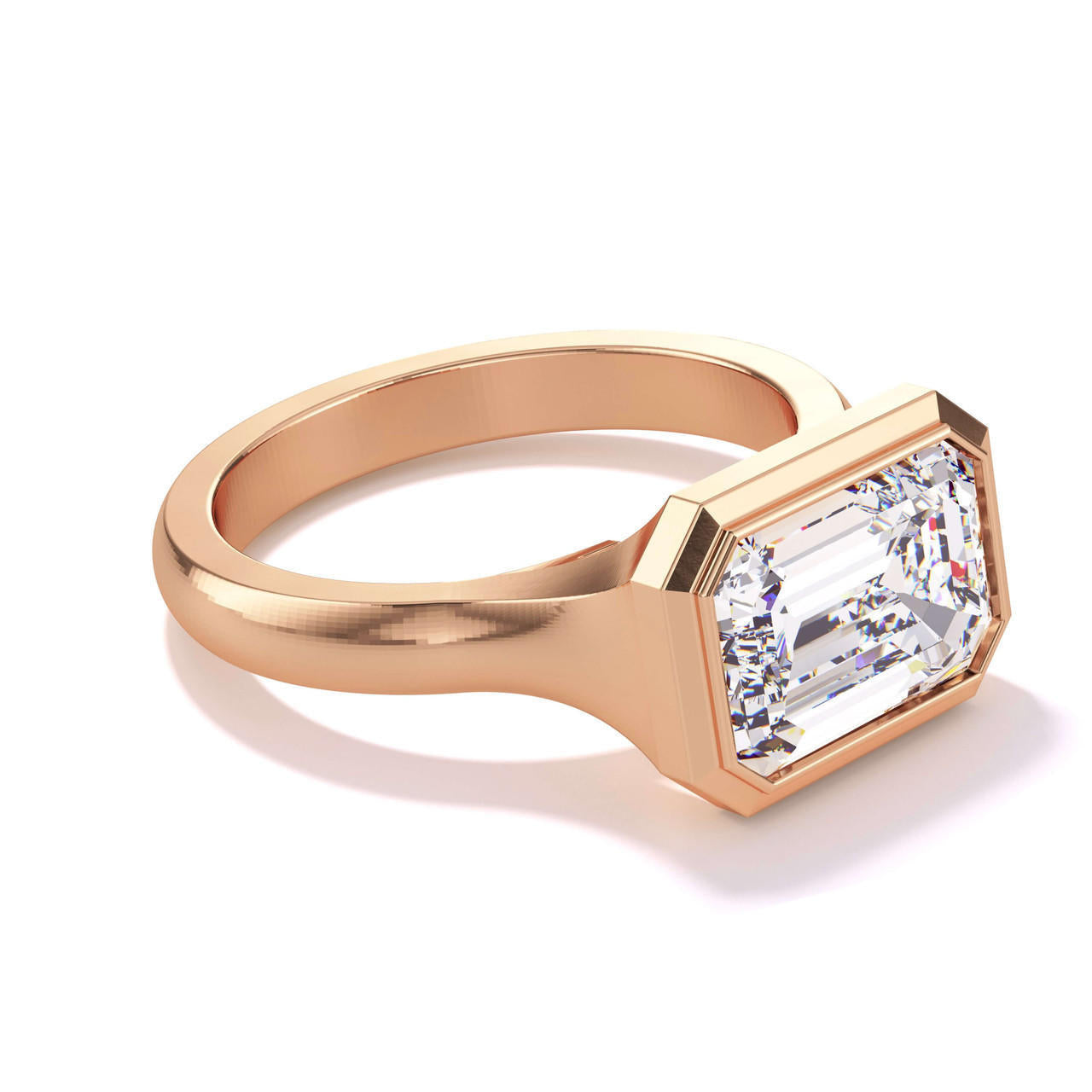 shield bezel set east west emerald cut engagement ring in 18k rose gold