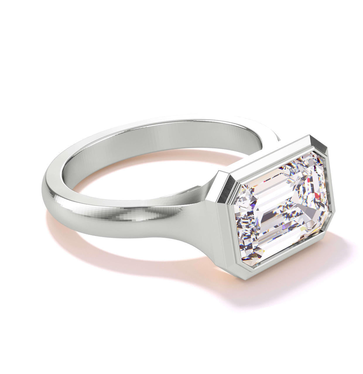 shield bezel set east west emerald cut engagement ring in platinum