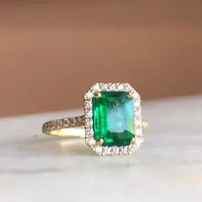 BESPOKE EMERALD CUT EMERALD RING WITH HALO