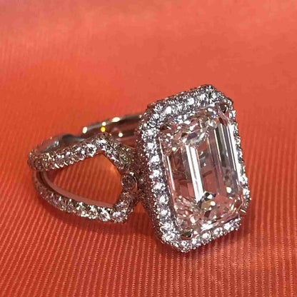BESPOKE EMERALD CUT DIAMOND ENGAGEMENT RING WITH HALO
