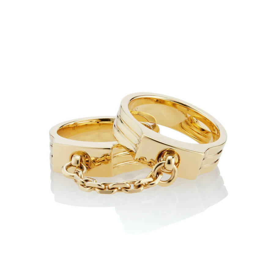 oath double finger ring with chain set in yellow gold with chain detail stacked