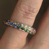 Lindsey Scoggins Studio’s Rainbow Sapphire and Diamond Continuum Band, modeled on a hand.
