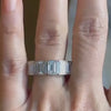 Bezel Set Emerald Cut Diamond 10 Carat Eternity Band, modeled on a hand.