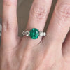 Close-up view of a green tourmaline ring accented with white pave diamonds