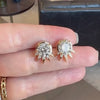 A hand holding Lindsey Scoggins Studio’s Custom Diamond Stud Earrings with Spikes inspired by the Statue of Liberty.