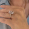 A Custom Emerald Cut Diamond Engagement Ring modeled on a hand.