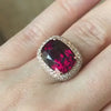 Garnet Ring in a Pave Diamond Basket, modeled on a hand.