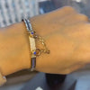 Close-up of a Sapphire and Diamond Oath Cuff modeled on a wrist.