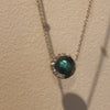 Close-up of Lindsey Scoggins Studio’s Pearl and Diamond Moon Necklace.