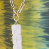 Lindsey Scoggins Studio’s Three-tile zodiac pendant necklace featuring Sagittarius and star symbols.