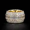 Wide yellow gold band ring featuring rows of round and baguette diamonds in a bold pavé design.