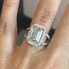 Lindsey Scoggins Studio’s Emerald Cut Diamond Engagement Ring with Halo, modeled on a hand.