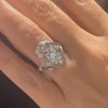 A custom Vintage Replica Ring by Lindsey Scoggins Studio worn on a hand.