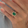 Emerald Engagement Ring with Links Band modeled on a hand.