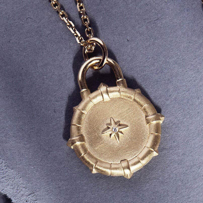 The FINDER diamond and gold pendant front view